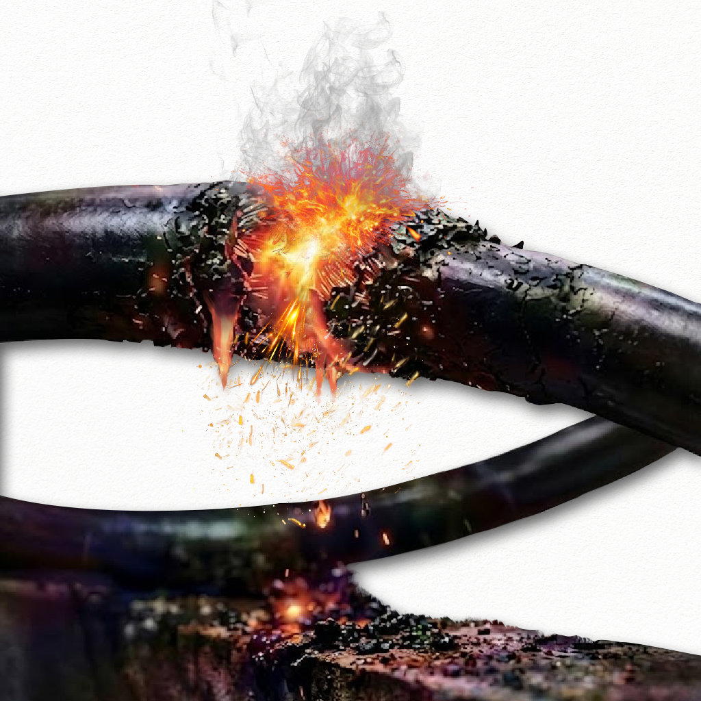 Close-up of sparks, smoke, and an electrical arc at a break in a black plastic pipe.